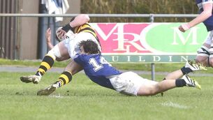 <p>Portlaoise's Marc Bracken denies Newbridge's Max McLoughlin his try at Togher on Sunday Photo: Denis Byrne</p>