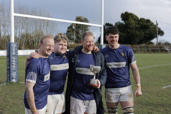 Joe Stevens (holding the cup) was playing his last game for Portlaoise before returning home to England, pictured with Iain Corrigan, Ryan McEvoy and Cormac Rigney