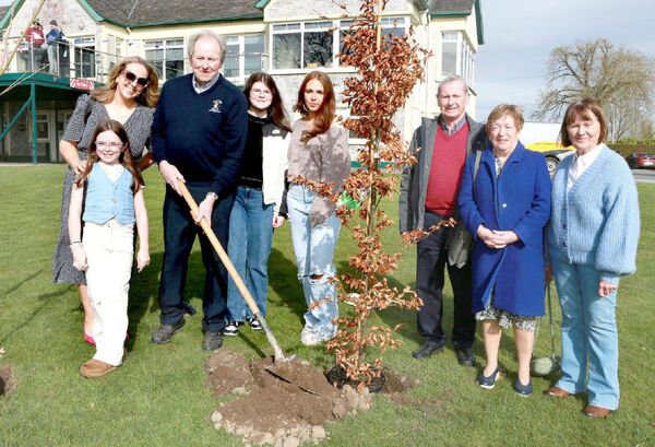 Pat Culleton planting a tree with family members