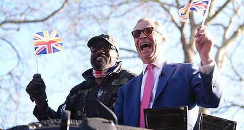 Derek Chisora arrives at media event in army tank with Nigel Farage