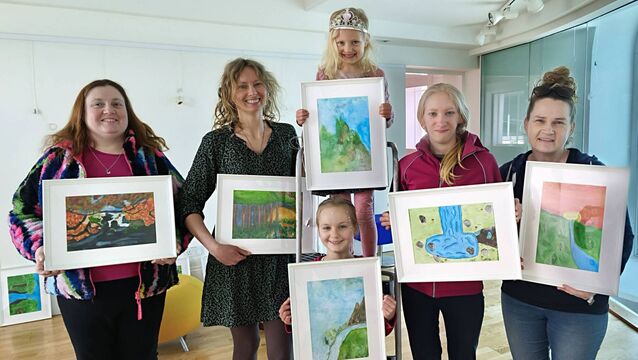 <p>Pictured on the first hanging day in Mountmellick Library are senior library assistant Karen Lambe, artist and joint parents association treasurer Edyta O'Shea with her three daughters Lena, Gaia and Aya and parents association PRO Lynn Ryder Photos: Stan Henderson</p>