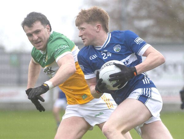 Rioghan Murphy (Laois) in possession with Diarmuid Egan (Offaly) moving in to challenge Photo: Denis Byrne