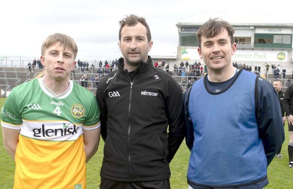 Captains David Dempsey (Offaly) and Brian Byrne (Laois) with referee Paul Faloon ahead of throw in at Glenisk O'Connor Park on Saturday Photo: Denis Byrne