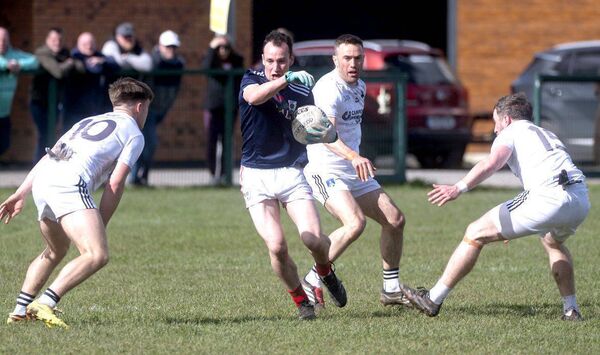 Shay Foynes (Clonaslee/St Manman's) in possession but surrounded by Courtwood players Photo: Denis Byrne