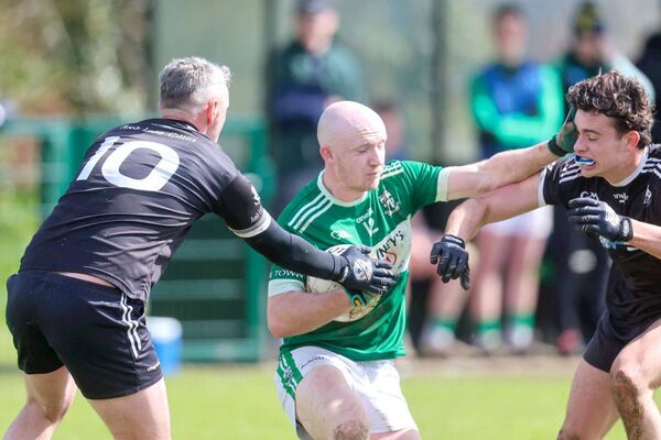 Portlaoise's Ben Brennan wards off the attempted tackles from these Arles Killeen players Photo: Paul Dargan