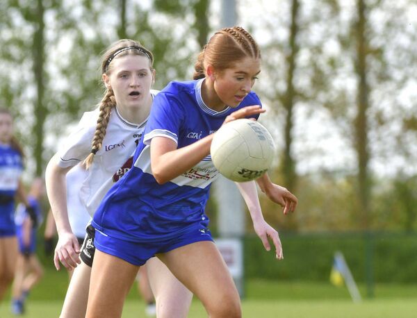 Poppy Duff (Laois) breaking as Kildare's Aibigeal Corcoran tries to catch her Photo: Denis Byrne