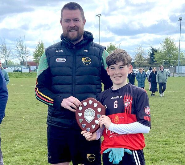 Portlaoise CBS captain, Billy Conroy is presented with the Br Hubert Shield