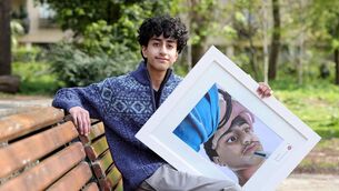 <p>Abdul Ahad Zulfiqar from Portlaoise CBS with his prize-winning portrait</p>