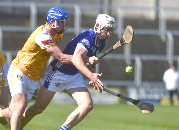 Laois's Martin Phelan looks to secure this sliotar while challenged by Antrim's Oisin Donnelly 	 Photo: Denis Byrne