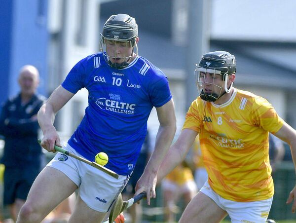 James Doherty (Laois) breaking with Gerard Delaney (Antrim) moves in to challenge Photo: Denis Byrne