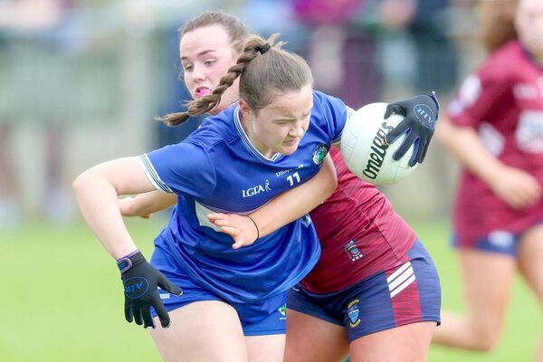 Laois's Niamh Dundon drives past this Westmeath defender in the Leinster Minor 'B' final	 Photo: Paul Dargan
