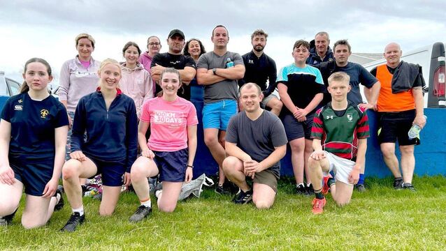 <p>A group of Touch Rugby players at Portlaoise RFC in 2025 with Head Coach Mark Woolfield on the extreme right</p>