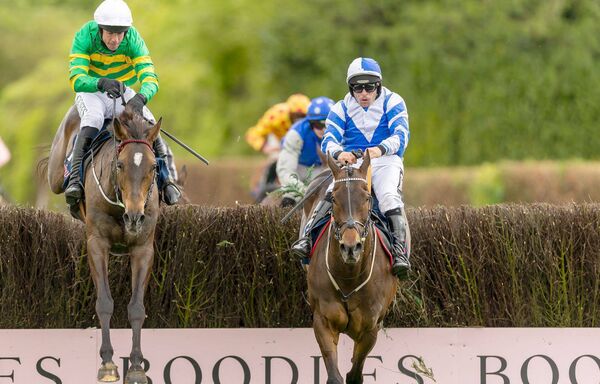 Rob James on Wonderwall (blue and white silks) holds off Derek O'Connor on It's On The Line to win The Uniquely Champion Hunters Steeplechase Photo: ©INPHO/Morgan Treacy