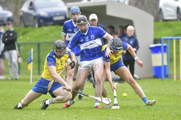 Matthew Peters (Castletown) vies for this sliotar with Lewis Churchouse and Jack Finlay (Abbeyleix) Photo: Denis Byrne