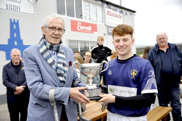 Peter Dunne presents the Michael Dunne Cup to Portlaoise captain Mark Kelly after his team's win over Carlow in the final on Sunday Photo: Martin Rowe