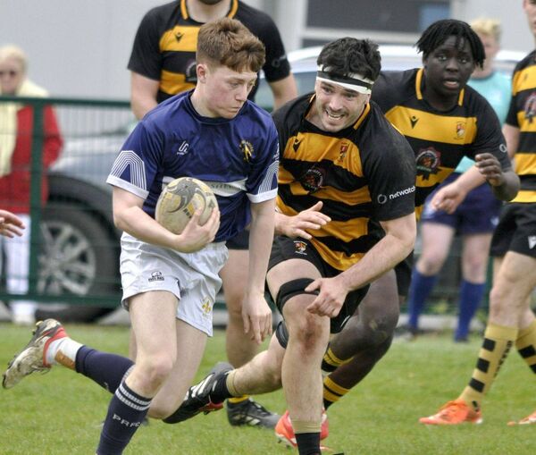 Mark Kelly spins around Carlow's Danny Carpenter in the Michael Dunne Cup final Photo: Martin Rowe