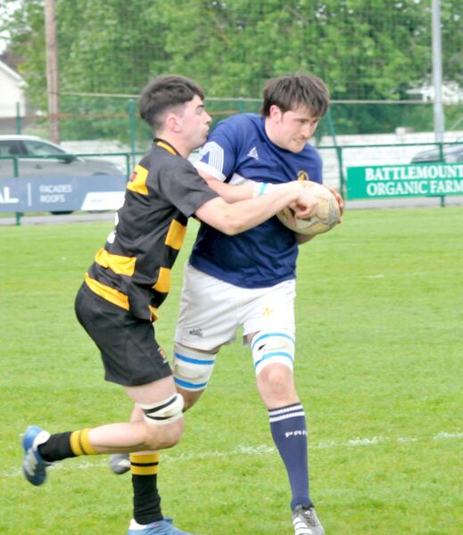 Aaron Kingston (Portlaoise) shakes off this tackle from Carlow's Tomas Whitney Photo: Martin Rowe 