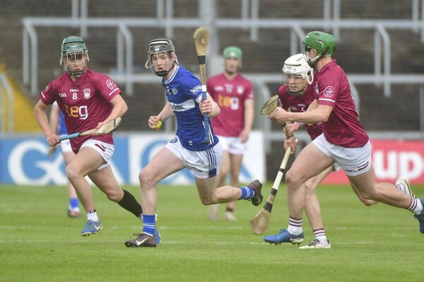 Laois captain Callum Jones breaking with Westmeath players give chase 	 Photo: Denis Byrne