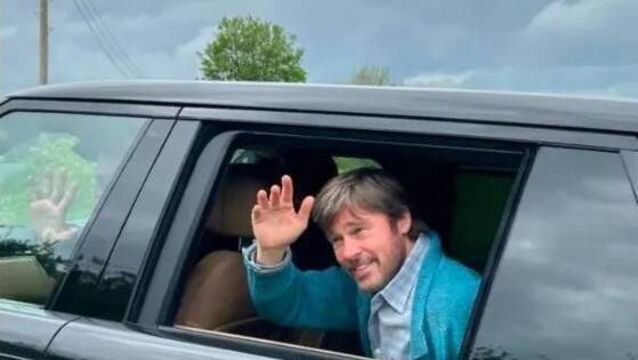 <p>Brad Pitt waves to fans as he leaves the set in Ballyadams</p>