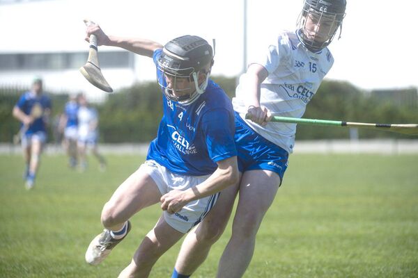 Ronan Conneely (Laois) hangs on to possession despite the close attention of Waterford's Ethan Neilon Photo: Denis Byrne Ronan Conneely (Laois) hangs on to possession despite the close attention of Waterford's Ethan Neilon Photo: Denis Byrne