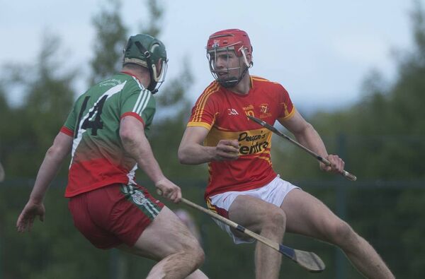 Jack Kennedy of The Harps in possession with Borris Kilcotton's Neil Foyle staying close. Photos: Denis Byrne. Jack Kennedy of The Harps in possession with Borris Kilcotton's Neil Foyle staying close. Photos: Denis Byrne.