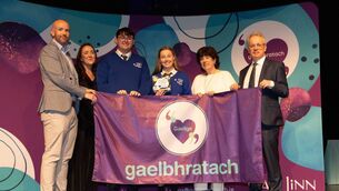 <p>Students from Dunamase College, Portlaoise, are presented with their Gaelbhratach (Irish flag) at Mary Immaculate College this week. Photograph by Eamon Ward</p>