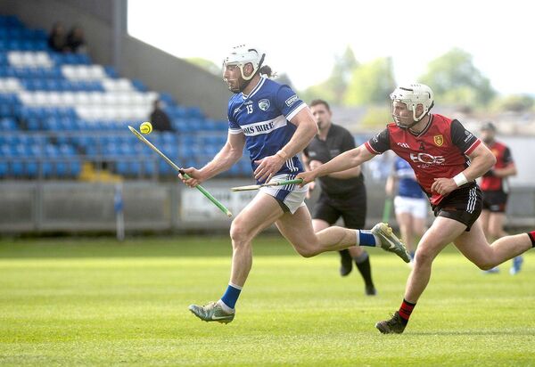 Laois's Ben Conroy breaking with Ben Taggart (Down) giving chase 	 Photos: Denis Byrne