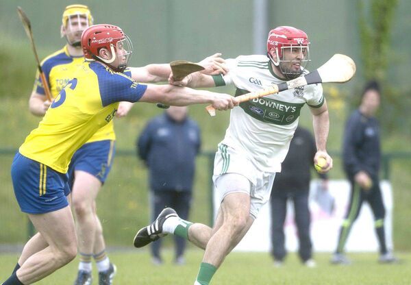 Portlaoise's Ryan Denny battles to get clear of Aaron Carroll (Abbeyleix) Photo: Denis Byrne