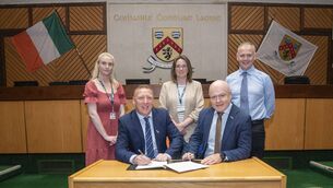 <p>Cathaoirleach Barry Walsh and chief executive Michael Rainey signing the Climate Action Charter, with director of Services Pat Delaney, Suzanne Dempsey, and Anne Lennon. Photo: Denis Byrne</p>