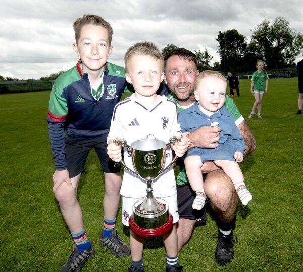 Stradbally Town's Jody Dillon with some special young fans Photo: Denis Byrne