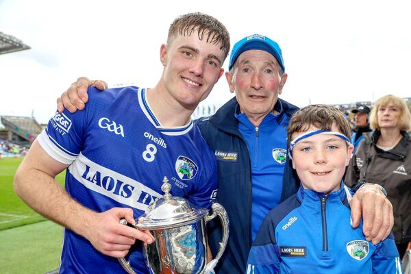Laois captain David Dooley with Pat Delaney and a very happy young supporter 