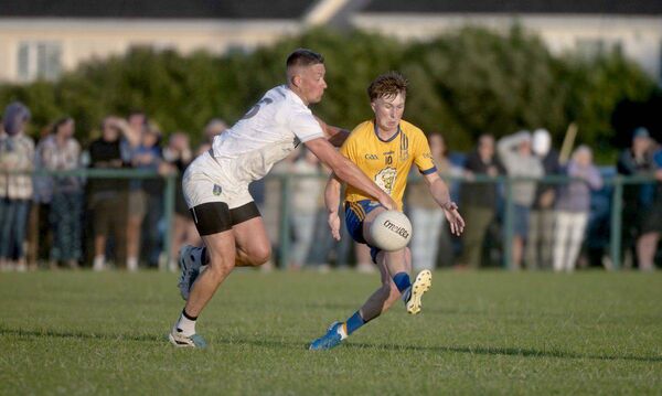 Jack Gorman (St Josephs) soloing as Barry Donnelly (Courtwood) moves to disposses 	 Photo: Denis Byrne