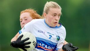 <p>Laois's Mary Cotter shows great determination to break through this tackle to clear her lines on Saturday 	 Photo: Paul Dargan</p>
