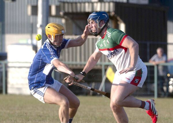 Rory Kelly (Castletown) and Patrick Hassett (Rathdowney/Errill) compete for this sliotar Photo: Denis Byrne Rory Kelly (Castletown) and Patrick Hassett (Rathdowney/Errill) compete for this sliotar Photo: Denis Byrne