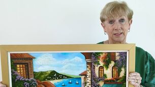 <p>Artist Anne Sands from Mountmellick pictured with one of her 35 paintings in her 'The Colourful Collection' exhibition currently on show in Mountmellick Library Photos: Stan Henderson</p>
