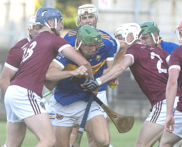 Ronan Broderick (Clough/Ballacolla) break through the combined tackle of Jamie Drury and Cathal O'Shaughnessy (Ballinakill) Photo: Denis Byrne Ronan Broderick (Clough/Ballacolla) break through the combined tackle of Jamie Drury and Cathal O'Shaughnessy (Ballinakill) Photo: Denis Byrne