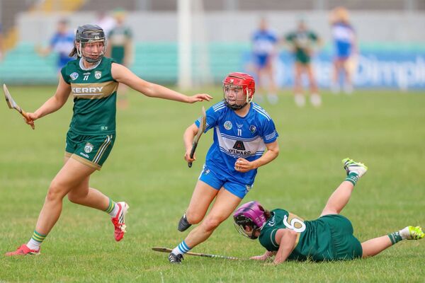 Laois's Graine Delaney leaves these Kerry defenders floundering in her wake as she strides forward in the All-Ireland semi-final 	Photo: Paul Dargan