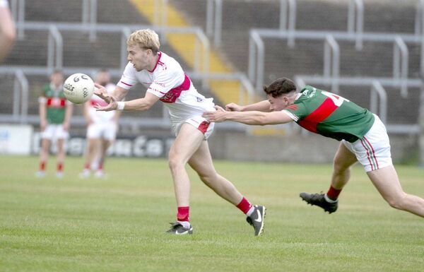 Sean Greene (Emo) laying this ball off as Seanie McGrath (Graiguecullen) attempts to challenge Photo: Denis Byrne Sean Greene (Emo) laying this ball off as Seanie McGrath (Graiguecullen) attempts to challenge Photo: Denis Byrne