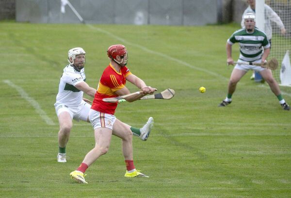 James Duggan (Harps) about to drive this sliotar on goal as Ciaran McEvoy (Portlaoise) attempts to block Photo: Denis Byrne James Duggan (Harps) about to drive this sliotar on goal as Ciaran McEvoy (Portlaoise) attempts to block Photo: Denis Byrne