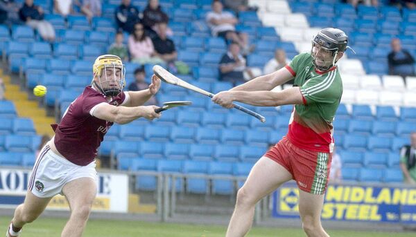 Aaron Dunphy (Borris/Kilcotton) firing this sliotar on goal despite the best effort of Ian Shanahan (Ballinakill) to block him Photo: Denis Byrne Aaron Dunphy (Borris/Kilcotton) firing this sliotar on goal despite the best effort of Ian Shanahan (Ballinakill) to block him Photo: Denis Byrne