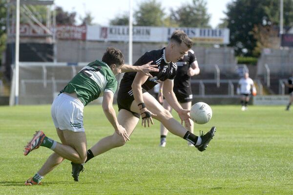 Colin Dunne (Arles Killeen) makes ground as Gary Whelan (Portlaoise) moves to challenge Photo: Denis Byrne Colin Dunne (Arles Killeen) makes ground as Gary Whelan (Portlaoise) moves to challenge Photo: Denis Byrne