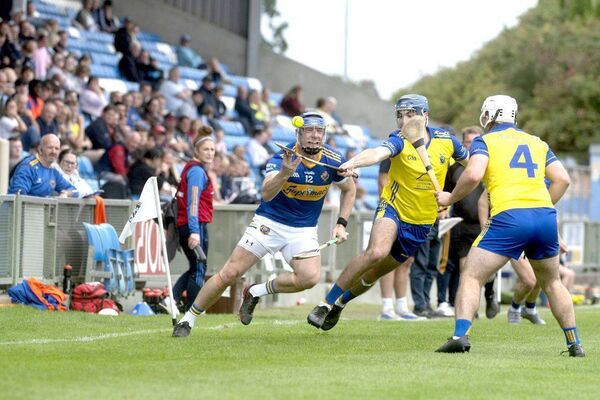 Stephen Maher (Clough/Ballacolla) releasing this sliotar as Stephen O'Donnell (Abbeyleix) challenges Photo: Denis Byrne Stephen Maher (Clough/Ballacolla) releasing this sliotar as Stephen O'Donnell (Abbeyleix) challenges Photo: Denis Byrne