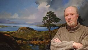 <p>Paul Guilfoyle with one of his beautiful landscape paintings</p>
