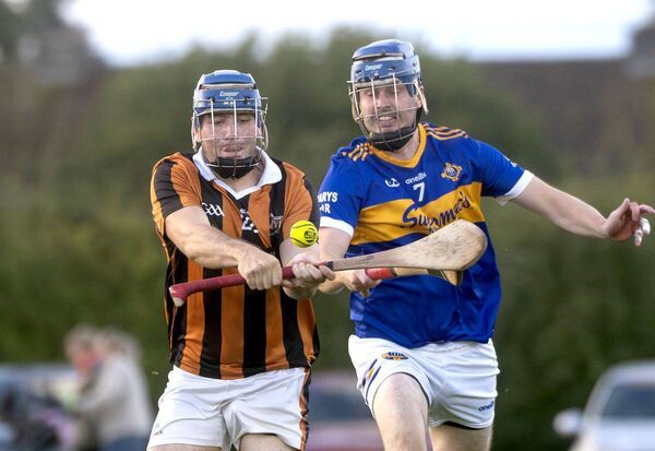 Sean Devaney (Camross) playing this sliotar as Craig Saunders (Clough/Ballacolla) moves to hook 	Photo: Denis Byrne