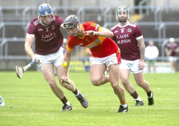 Ciaran Flynn (Harps) lifting this sliotar with Brian Duggan (Ballinakill) challenging Photo: Denis Byrne Ciaran Flynn (Harps) lifting this sliotar with Brian Duggan (Ballinakill) challenging Photo: Denis Byrne