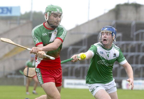 Eoghain Coss (Borris/Kilcotton) gets his shot away despite Oran Gorman's (Rosenallis) effort to hook in their SHC Rd 5 game on Sunday Photo: Denis Byrne Eoghain Coss (Borris/Kilcotton) gets his shot away despite Oran Gorman's (Rosenallis) effort to hook in their SHC Rd 5 game on Sunday Photo: Denis Byrne