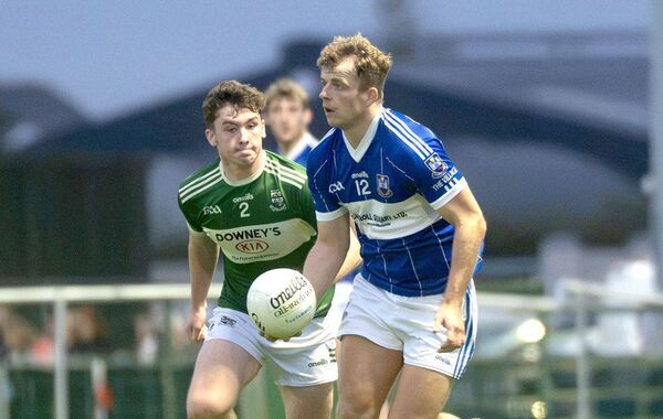 Conor Phelan (Castletown) looking to release this ball as Robbie Brophy (Portlaoise) keeps his eyes on the ball Photo: Denis Byrne Conor Phelan (Castletown) looking to release this ball as Robbie Brophy (Portlaoise) keeps his eyes on the ball Photo: Denis Byrne