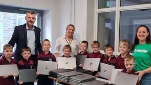 <p>Second class pupils with principal Mr Murrell, Helen Mulhare (HSCL) and parent Margaret Scott, who donated 30 laptops to the Mountmellick school. Photo: Scoil Phádraig Naofa</p> <p>Second class pupils with principal Mr Murrell, Helen Mulhare (HSCL) and parent Margaret Scott, who donated 30 laptops to the Mountmellick school. Photo: Scoil Phádraig Naofa</p>