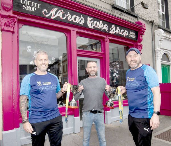 Pictured are Darren O'Reilly Proprietor "Noras Cake Shop" (Sponsor) with Darren Brooks and Gary Devane Road Runner Athletic Club Mountmellick with The Noel Coss &amp; Michelle Oxley Perpetual Cup