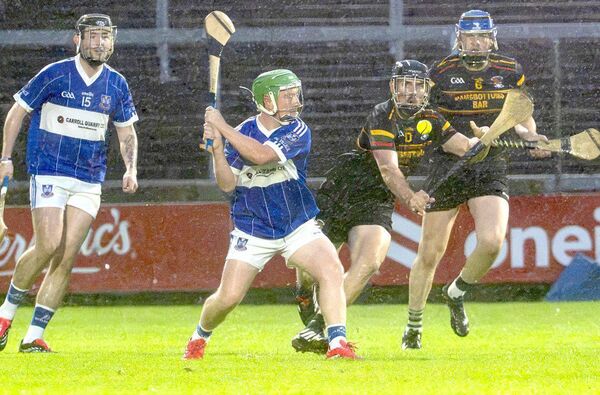 Aaron Gaughan (Castletown) playing for a score as Brian Fingleton (PRT) attempts to block 	 Photo: Denis Byrne 